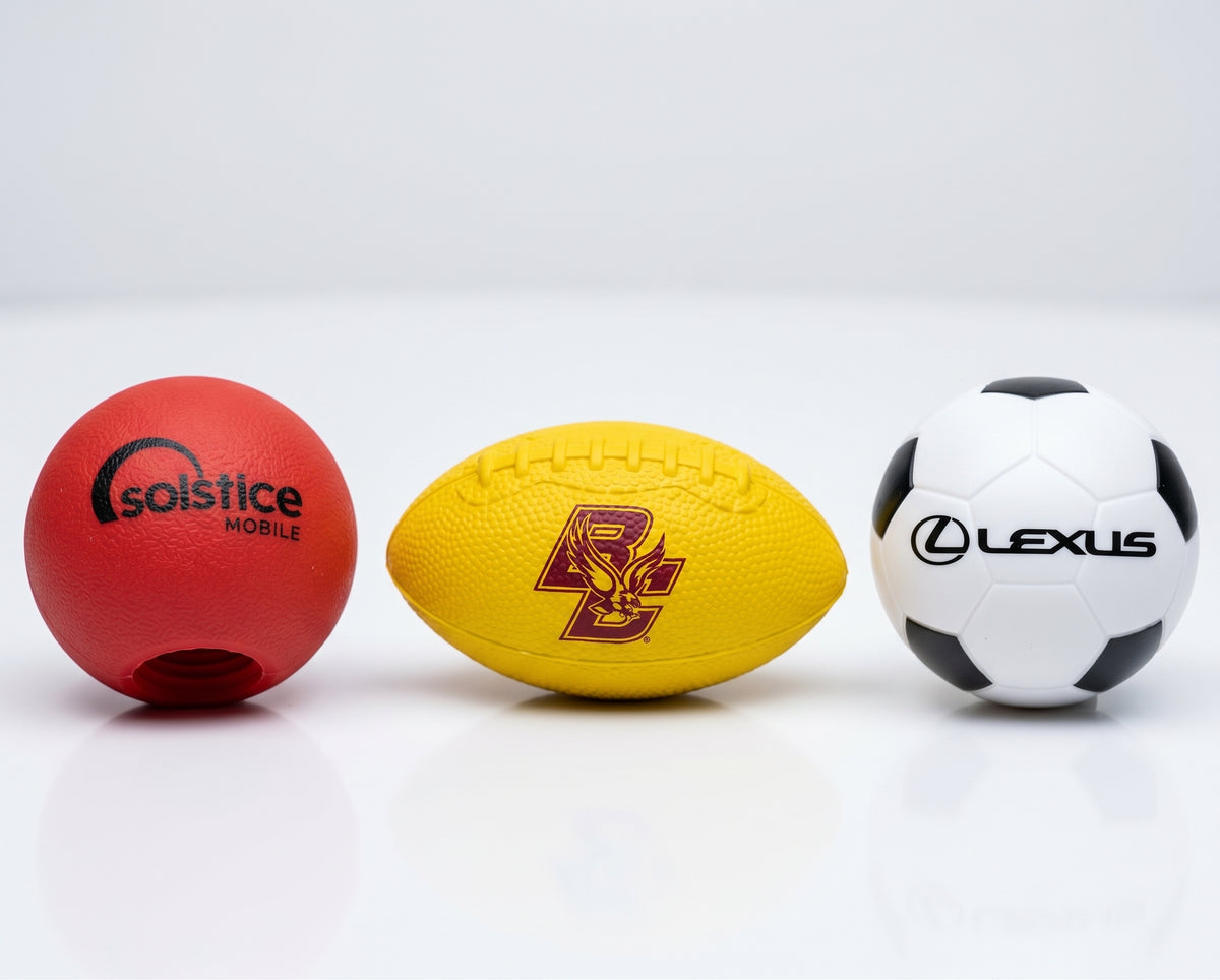 Custom branded stress balls : a red Solstice Mobile ball, a yellow football with a burgundy USC logo & a white soccer ball